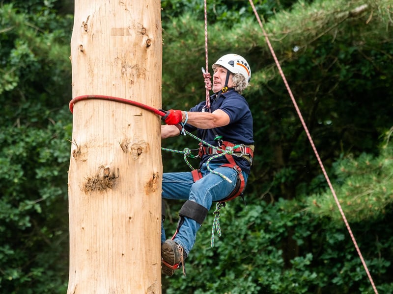 Andy Kirkwood, aged 61, taking part in the Pole Climbing competition