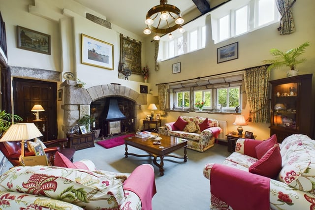 The living room offers a cosy retreat with a stone fireplace and mullion windows to the front elevation of the property.