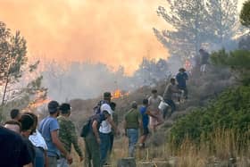 Local people trying to put out the wildfires on the island of Rhodes, Greece, in July. PIC: Sarah George/PA Wire