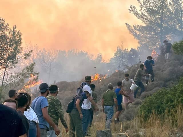 Local people trying to put out the wildfires on the island of Rhodes, Greece, in July. PIC: Sarah George/PA Wire