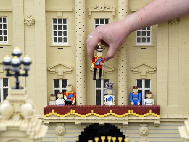 Library image of model maker Daniel Anderson from the Legoland Windsor Resort, placing a Lego model of King Charles III onto the balcony of Buckingham Palace as part of a coronation miniland scene,  before the coronation of King Charles III. (Photo by PA Wire/PA Images)