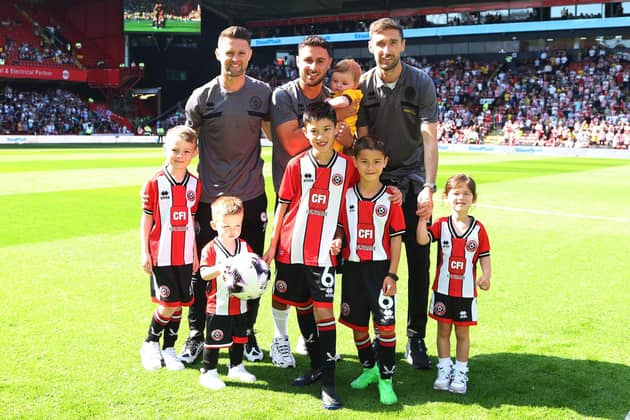 DEPARTING: (Left to right) Oliver Norwood, George Baldock and Chris Basham say goodbye to Sheffield United with their children before the Premier League match against Tottenham Hotspur