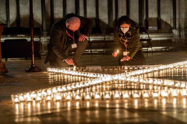 York Minster staff lighting the hundreds of candles for York Minster commemoration for Holocaust Memorial Day