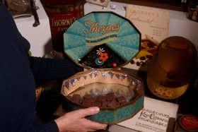 Vintage Sweets exhibition at Abbey House Museum - curator Kitty Ross pictured with a Thornes Toffee tin.