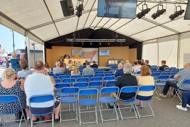 A group of people watched on as David Atherton performed a cooking demonstration.
