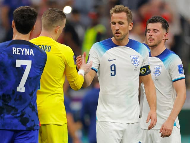 England's forward #09 Harry Kane (2nd R) greets England's goalkeeper #01 Jordan Pickford (2nd L) at the end of the Qatar 2022 World Cup Group B football match between England and USA at the Al-Bayt Stadium in Al Khor, north of Doha on November 25, 2022. (Photo by Odd ANDERSEN / AFP) (Photo by ODD ANDERSEN/AFP via Getty Images)
