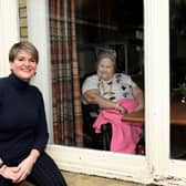 Elizabeth Hancock (L), Manager of Fulford Nursing Home with resident Julia behind the window .