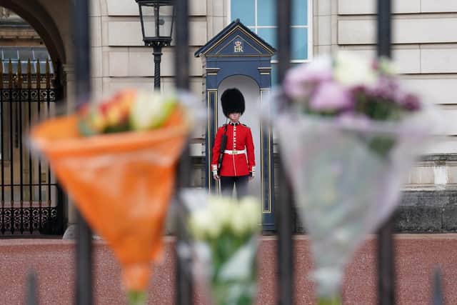 Boquet's of flowers are left on the gate at Buckingham Palace, London, following the death of Queen Elizabeth II.