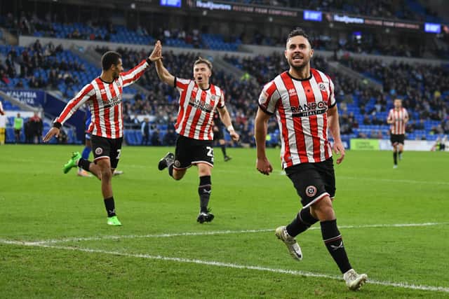 On the mark: Sheffield United’s George Baldock celebrates scoring the winning goal at Cardiff City on Saturday. (Picture: Simon Galloway/PA Wire