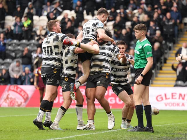Chris Satae is mobbed by Hull FC team-mates after scoring a second-half try. (Photo: John Clifton/SWpix.com)