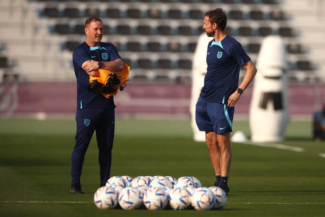 DOHA, QATAR - DECEMBER 09: Gareth Southgate (R), Head Coach of England, and Steve Holland, Assistant Coach of England look on during the England training session on match day -1 at Al Wakrah Stadium on December 09, 2022 in Doha, Qatar. (Photo by Robert Cianflone/Getty Images)