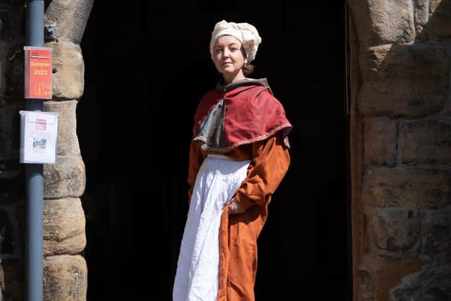 Helen Brayshaw, Solar Gallery artist, wears orange medieval kirtle worn with cloak and head wrap.Tanya says: “If you had your hair on display, you were either a bride on her wedding day or you were a prostitute or you were a queen. Queenship was meant to renew the virginity. It’s why Elizabeth I in her portraits as the Virgin Queen always has her hair on display.” Picture by Laura Mate.