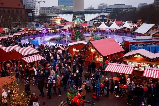 A general view shows visitors to the Berlin town hall Christmas market. (Pic credit: Odd Andersen / AFP via Getty Images)