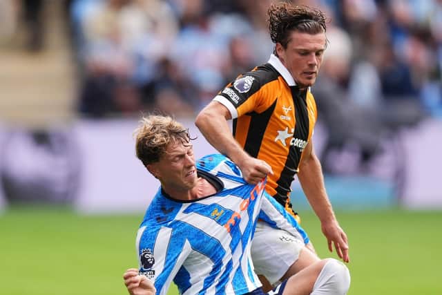 GETTING SHIRTY: Regan Slater gets to grips with Victor Torp (Image: Press Association)