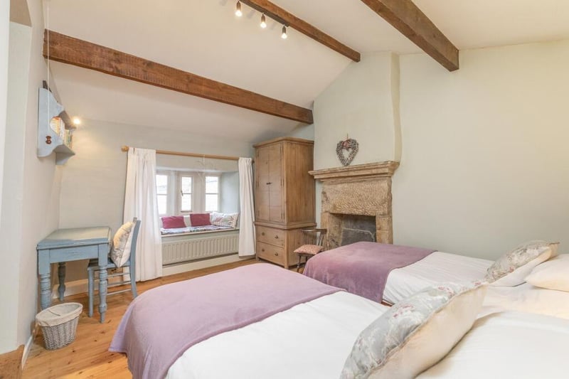 This large bedroom with twin beds and fireplace is one of the prettiest rooms in the cottage