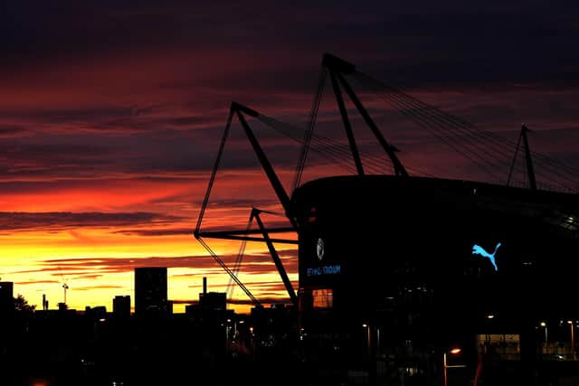 A general view from outside the Etihad Stadium with the sun setting in the background. PIC: Martin Rickett/PA Wire