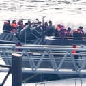 A group of people thought to be migrants are brought in to the Border Security Command compound in Dover, Kent. PIC: Gareth Fuller/PA Wire
