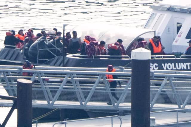 A group of people thought to be migrants are brought in to the Border Security Command compound in Dover, Kent. PIC: Gareth Fuller/PA Wire