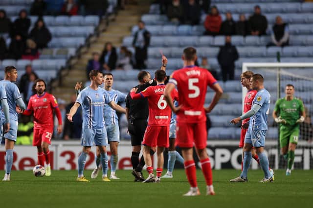 COVENTRY, ENGLAND - NOVEMBER 01: Jake Garrett of Blackburn Rovers receives a red card from Referee Tim Robinson during the Sky Bet Championship between Coventry City and Blackburn Rovers at The Coventry Building Society Arena on November 01, 2022 in Coventry, England. (Photo by Ryan Pierse/Getty Images)