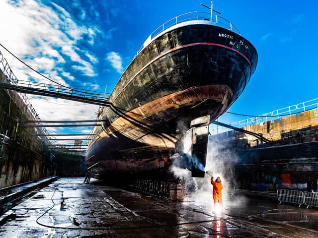 Date: 9th November 2021.
Picture James Hardisty.
The Arctic Corsair, a deep-sea trawler, built in 1960, that was converted to a museum ship in 1999. Is temporarily berthed in dry dock at Dunstonâ€™s shipyard on William Wright Dock in Hull as she start her restoration project. Pictured Ken Knaggs, Water blaster and painter for Dunston's Ship Repairs Ltd based in Hull power washing the hull whilst she is in dry dock.