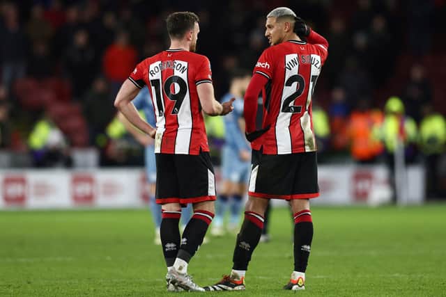 Backs against the wall: But Chris Wilder believes Sheffield United's players, including Jack Robinson, left, and Vinicius Souza, right, will come out fighting at Luton Town on Saturday (Picture: Darren Staples/AFP/Getty)