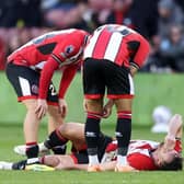 INJURY: Sheffield United's Jack Robinson in pain at the end of the Premier League game against Chelsea