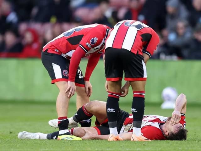INJURY: Sheffield United's Jack Robinson in pain at the end of the Premier League game against Chelsea