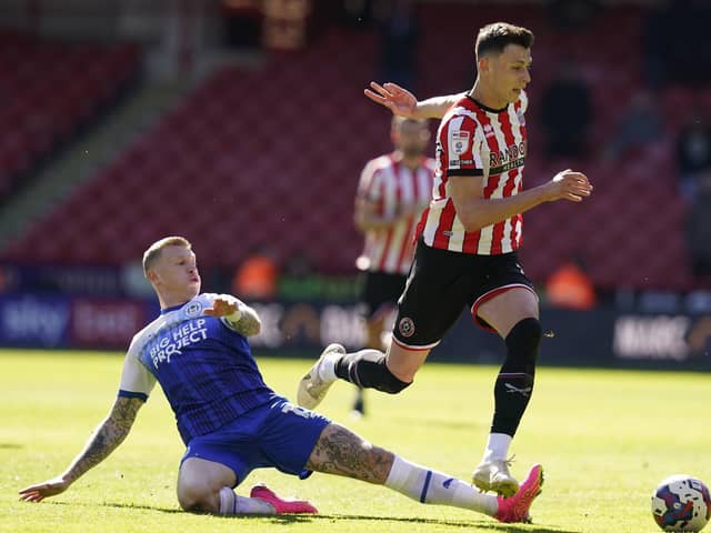 FRUSTRATIONS: Anel Ahmedhodzic of Sheffield United is tackled by James McClean of Wigan Athletic