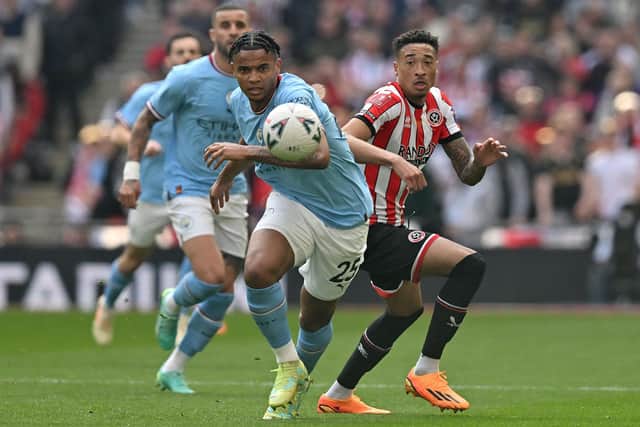 Sheffield United striker Daniel Jebbison (R) vies with Manchester City's Swiss defender Manuel Akanji during the English FA Cup semi-final. Jebbison would later give away a penalty (Picture: GLYN KIRK/AFP via Getty Images)