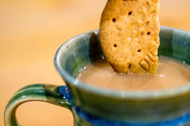 A photo of a digestive biscuit being dipped in tea. PIC: Alamy/PA.