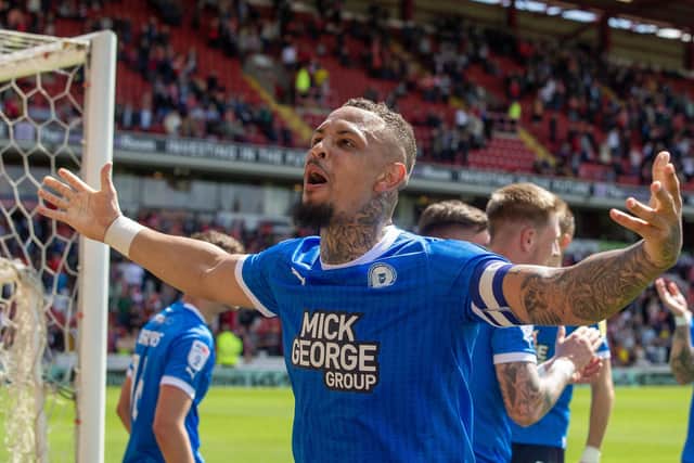 Peterborough United’s Jonson Clarke-Harris celebrate after finishing in the playoffs following victory in the Sky Bet League One match at Oakwell Stadium (Picture: PA)