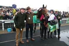Winning smiles: Bravemansgame with jockey Harry Cobden, trainer Paul Nicholls, right, and winning connections.