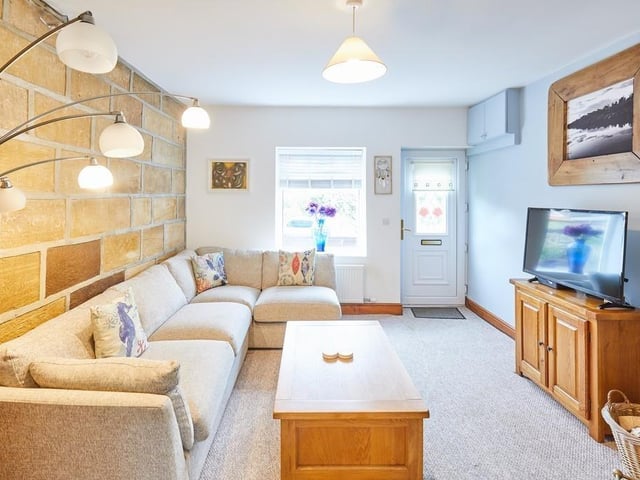 Another view of the sitting room with stone wall exposed to add character and texture