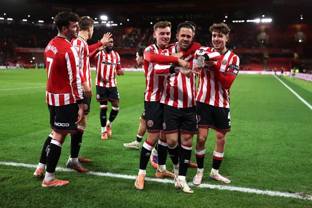 SHEFFIELD, ENGLAND - DECEMBER 09: Danny Ings of Sheffield United celebrates scoring his team's first goal with teammates, including returning captain Ollie Arblaster, far right, during the Sky Bet Championship match between Sheffield United and Norwich City at Bramall Lane on December 09, 2025 in Sheffield, England. (Photo by George Wood/Getty Images)