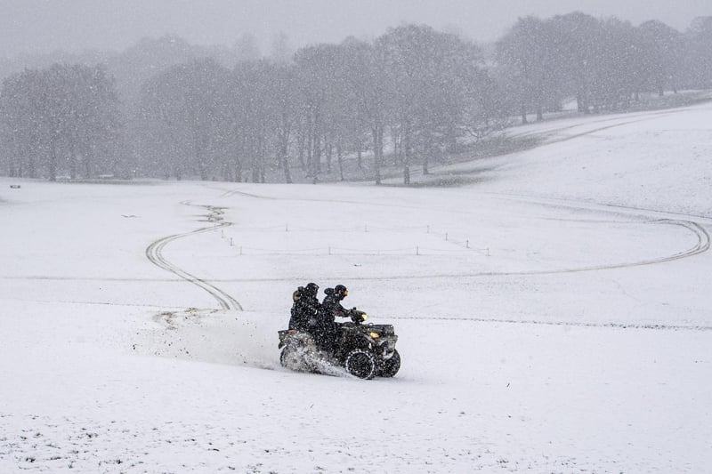 A couple on a quad bike rip up in Roundhay Park, Leeds in heavy snow.