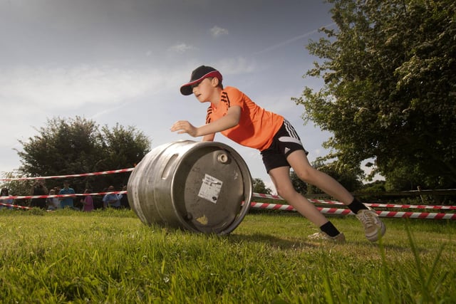 Competitors take part in the Barrel Push at Finghall. Picture taken by Yorkshire Post Photographer Simon Hulme 29th May 2023
