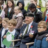 York's remaining D-Day veteran Ken Cooke with  pupils from Willow Tree Community Primary School as part of the CWGC 'Lighting Their Legacy' torch roadshow event series held at the Commonwealth War Graves Commission site at Stonefall Cemetery in Harrogate, as the 80th anniversary of D-Day gets closer,  photographed by Tony Johnson for The Yorkshire Post