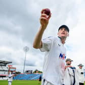 Ben Cliff holds the ball aloft after his eight-wicket haul against Somerset. Picture by Allan McKenzie/SWpix.com