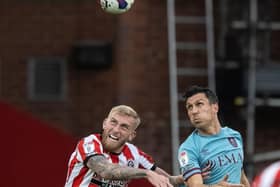 AERIAL THREAT: Burnley were unable to contain Oli McBurnie, pictured jumping for a header against Jack Cork, son of former Sheffield United striker Alan