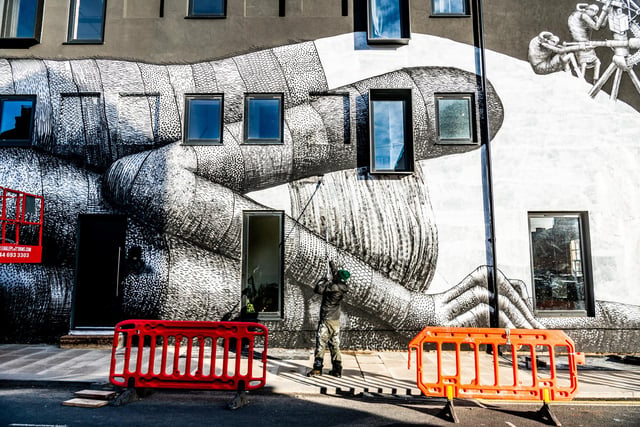 Artist known as Phlegm hard at work at the junction of Hilton Street, and Headford Street in Sheffield