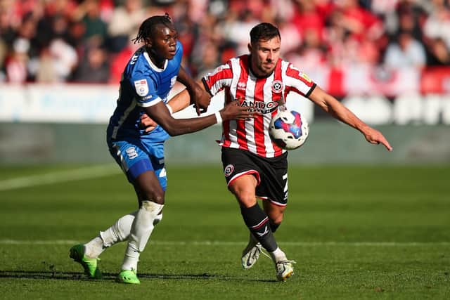 EVEN STEVENS: Sheffield United's George Baldock (right) and Birmingham City's Emmanuel Longelo battle for the ball at Bramall Lane, Sheffield. Picture: Isaac Parkin/PA