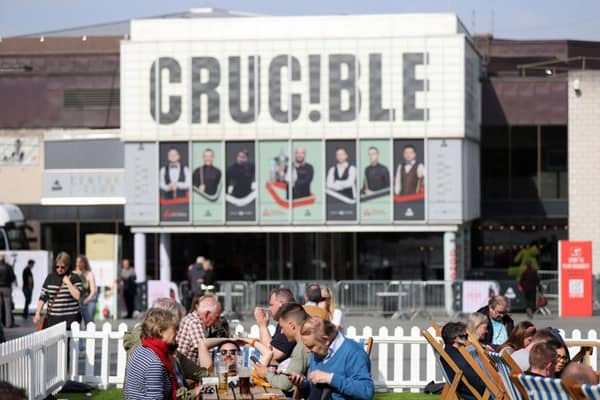People enjoy the sunny weather outside the Crucible Theatre during day thirteen of the Cazoo World Snooker Championship at Crucible Theatre. (Photo by George Wood/Getty Images)