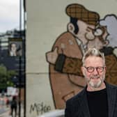 Sheffield artist Pete McKee by his famous mural The Snog on the gable end of Fagans pub in the city, which is the subject of a new exhibition, photographed for the Yorkshire Post Magazine by Tony Johnson.