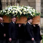 The coffin of Sir Bobby Charlton is carried by pallbearers out of Manchester Cathedral after the funeral service. PIC: Martin Rickett/PA Wire