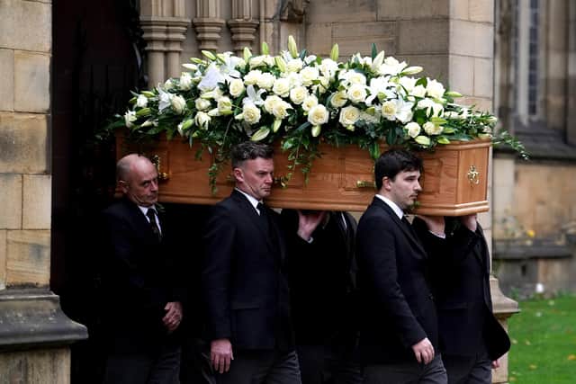 The coffin of Sir Bobby Charlton is carried by pallbearers out of Manchester Cathedral after the funeral service. PIC: Martin Rickett/PA Wire