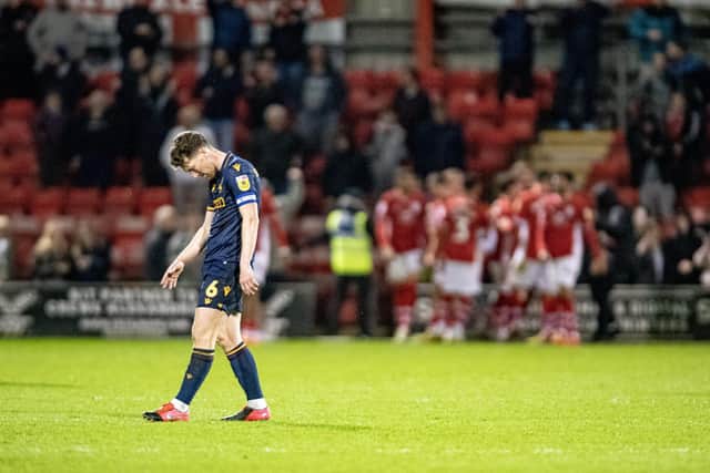 Bradford City captain Richie Smallwood is gutted after Crewe celebrate convering a late winning penalty. The midfielder was penalised for the late spot-kick. Picture: Tony Johnson.