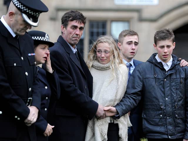 A memorial service held in Norfolk Gardens to mark the 10th anniversary of the death of PC Sharon Beshenivsky, who was shot dead outside a travel agency in Morley Street, in Bradford on the 18th November 2005, while responding to an armed robbery call. Pictured Sharon's shift parntner who was shot and injured Teresa Milburn, wipes a tear away, whilst her widow Paul, and their children Lydia, Josh, and Paul reflect on the past.