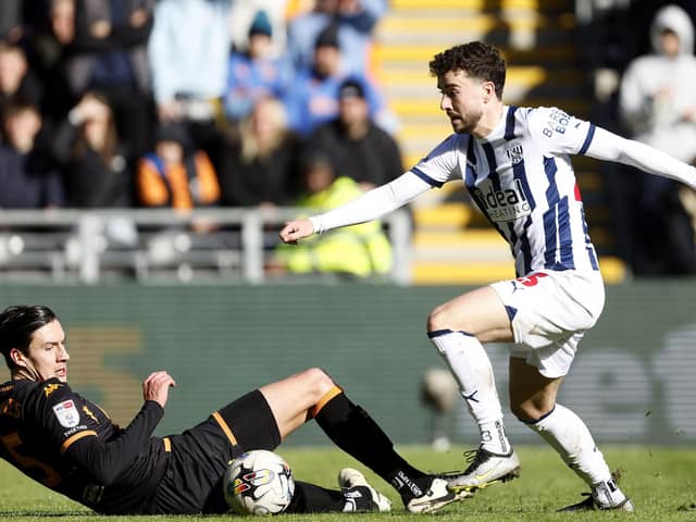 SITTER: Hull City's Alfie Jones (left) goes to ground when up against West Bromwich Albion's Mikey Johnston