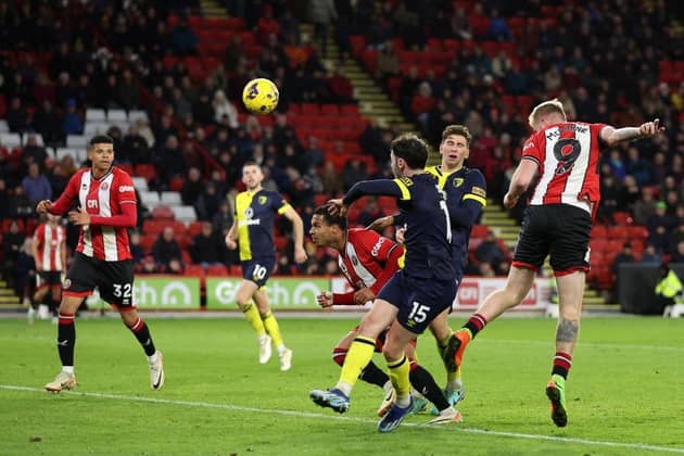 CONSOLATION: Oli McBurnie heads Sheffield United's goal in their 3-1 defeat to Bournemouth