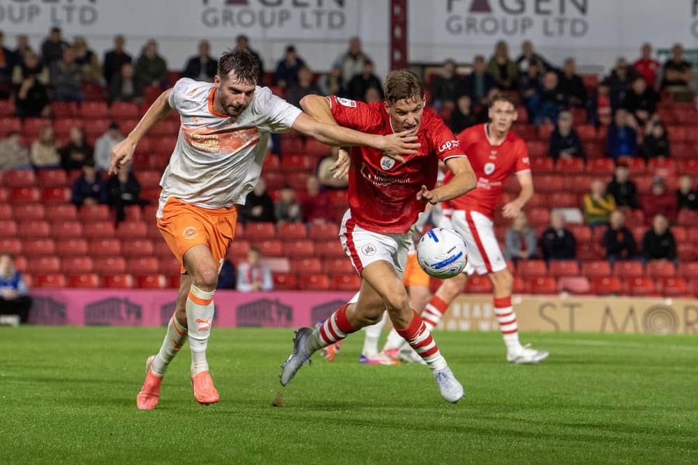Barnsley defender Sam Gale tussles with Blackpool's Tom Bloxham in the League One game earlier this month. Photo: Tony Johnson.